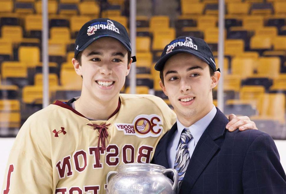 Brothers Johnny Gaudreau and Matthew Gaudreau arm in arm holding the Beanpot trophy